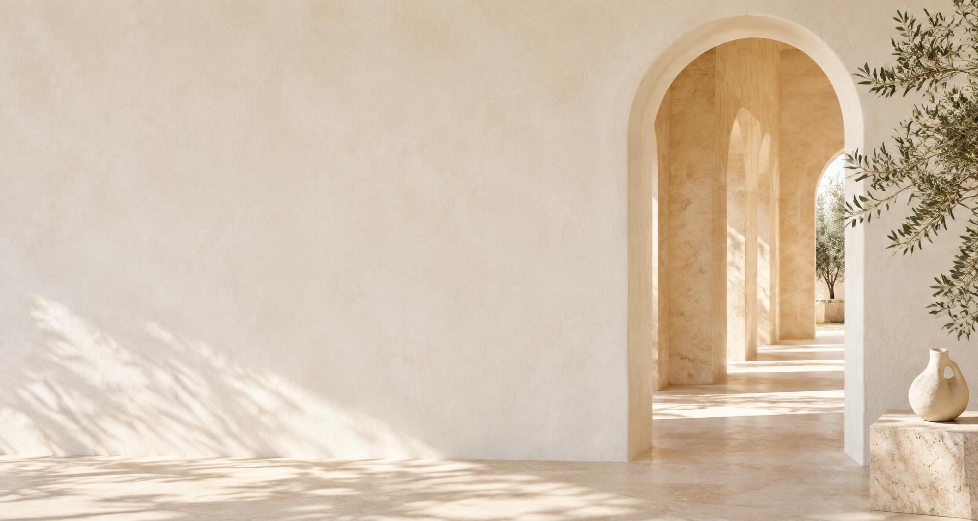 Sunlit ivory architecture with sculptural arches and an olive branch
